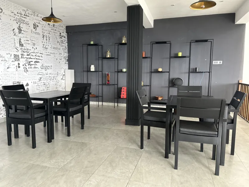 Indoor restaurant dining area with black tables and chairs at The Summit Kandy