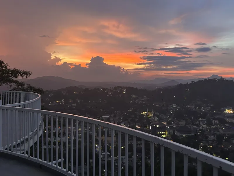 Curved rooftop terrace at sunset with panoramic views over Kandy city at The Summit Kandy